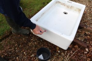 glue to the clean sides of the sink using a paintbrush