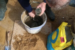 mixing hypertufa in a bucket