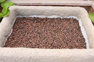 A thick layer of clay balls to add drainage to an alpine trough