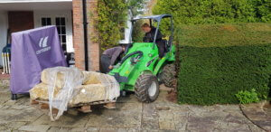 Building a rockery Moving stones with a forklift
